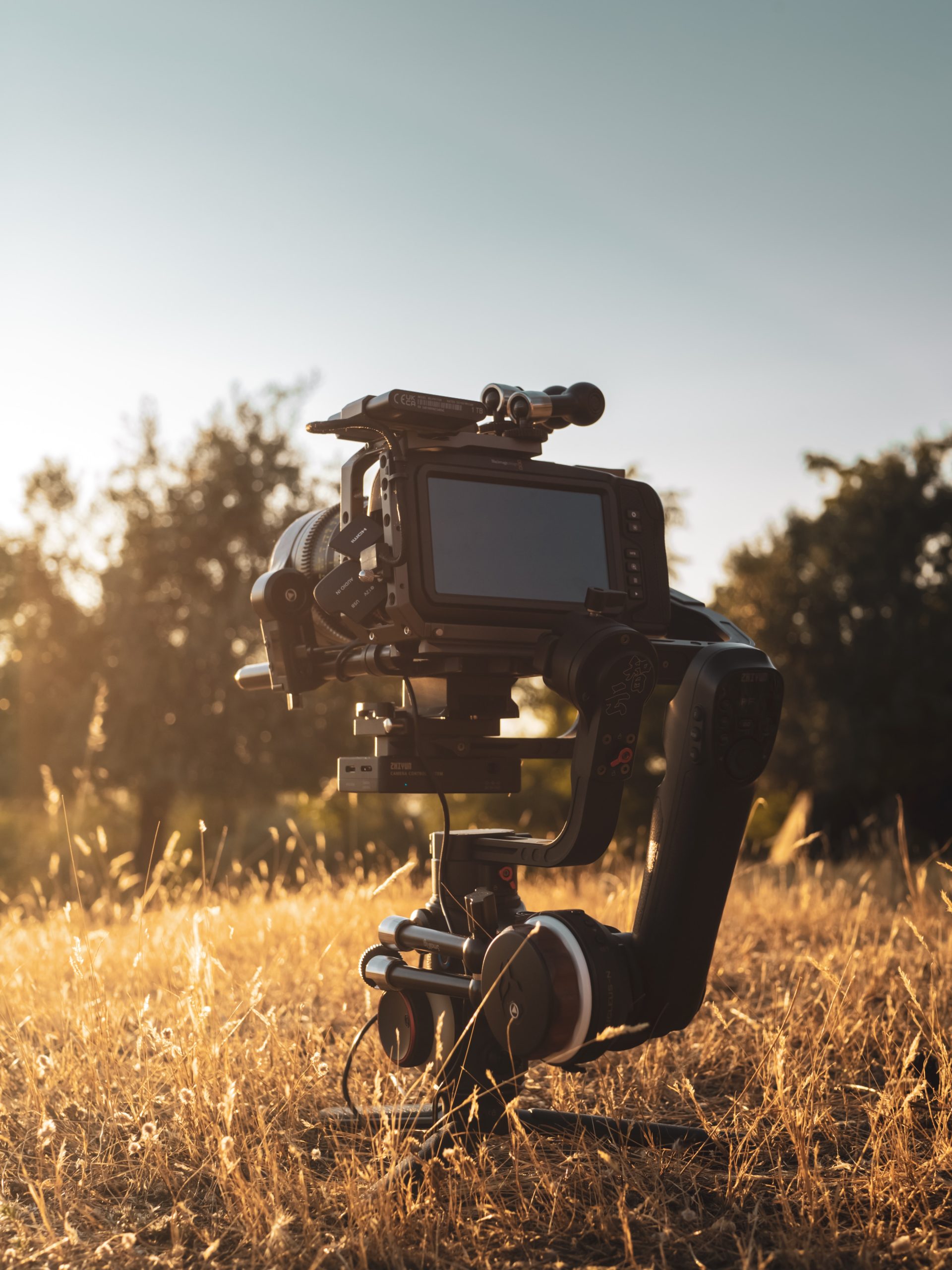 A gimbal on a tripod capturing stunning footage in a field for press releases.